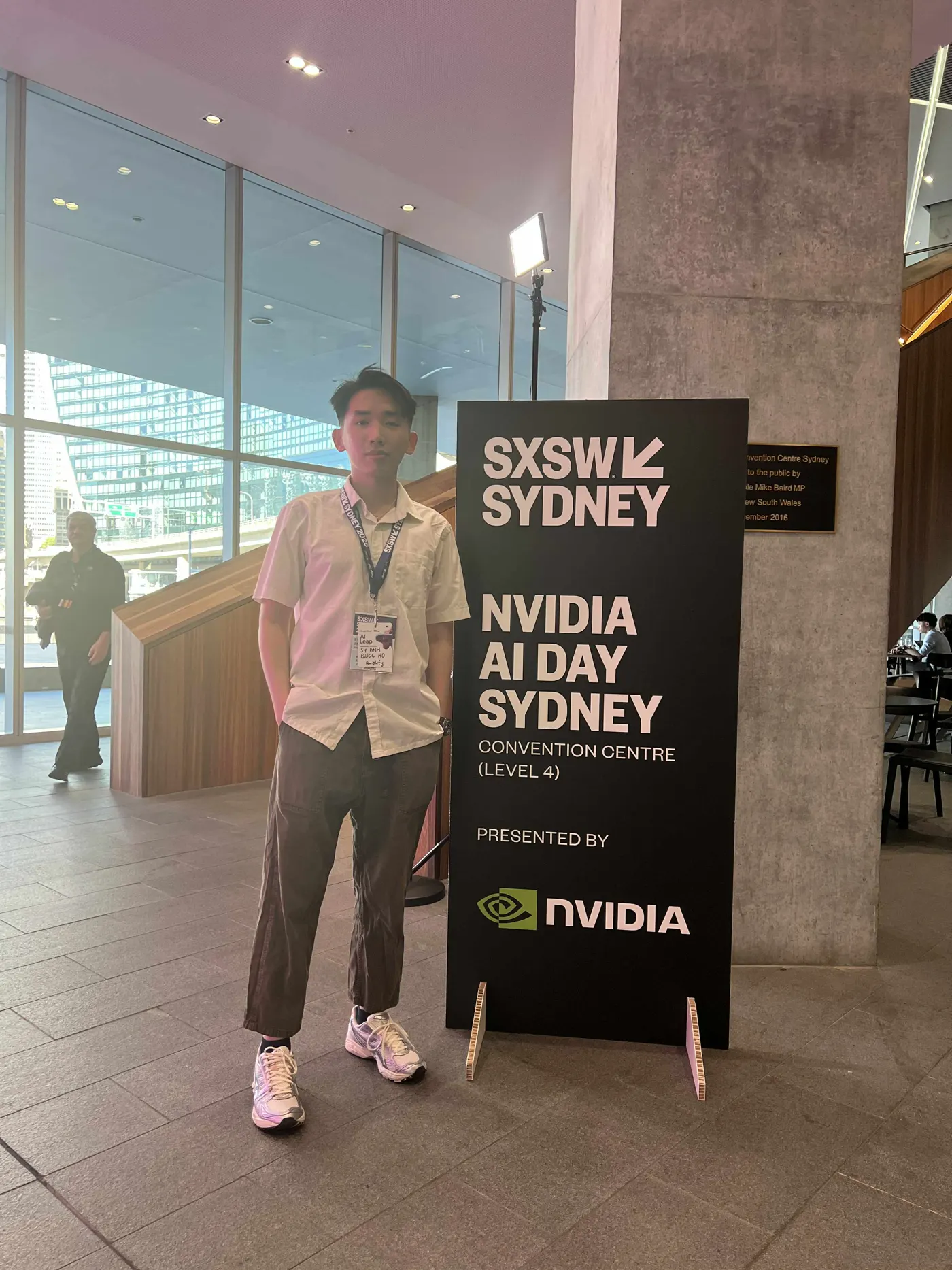 Johnny standing beside the NVIDIA AI Day Sydney sign at SXSW Sydney